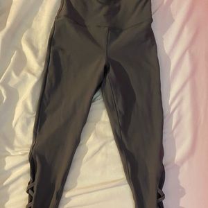 Grey leggings with designs on each leg.